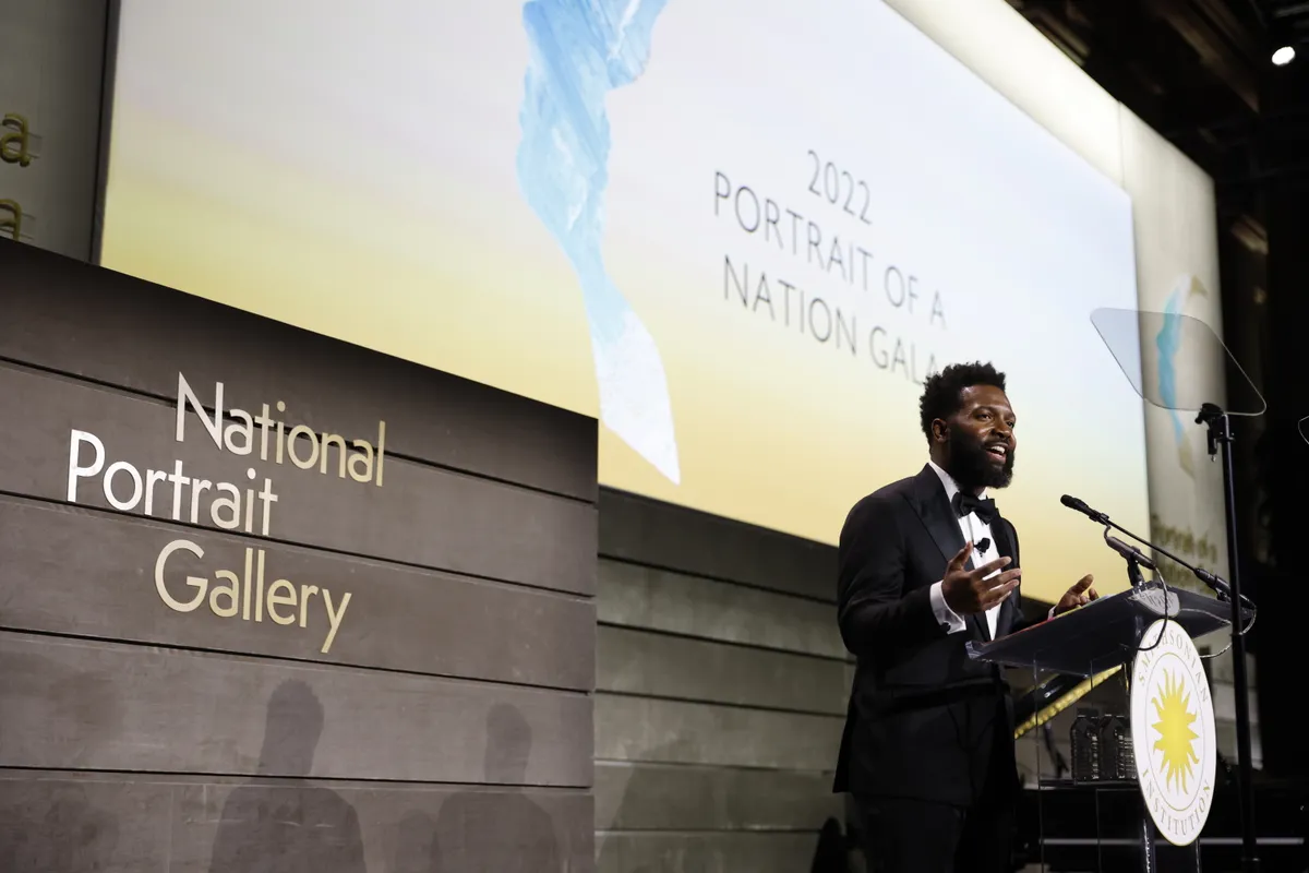 Baratunde Thurston hosting from the podium at the Portrait of a Nation Gala, Smithsonian National Portrait Gallery