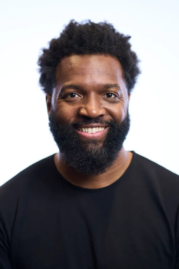 Baratunde Thurston headshot: Studio headshot, black tee
